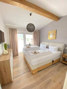 a bedroom with a large bed and a large window at Penthouse in Sonthofen in Sonthofen