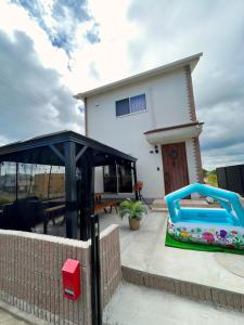 a house with a playground in front of it at 白浜リゾート・源 in Kanayama