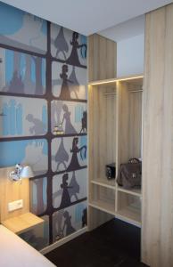 a bedroom with a wall with a dresser and a closet at Grimm's Potsdamer Platz in Berlin