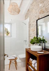 a bathroom with a sink and a mirror at Cuadra rehabilitada, piscina climatizada, Comillas in Lamadrid