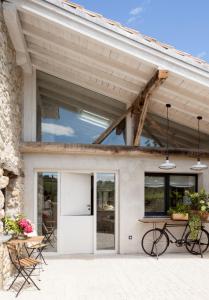 a patio with a table and a bike in front of a building at Wishome-Cuadra rehabilitada, piscina climatizada in Lamadrid