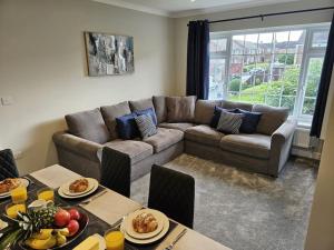 a living room with a couch and a table at Potter's Escape-walking distance from The Studios! in Abbots Langley