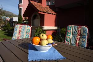 a bowl of fruit on a table with two chairs at Apartments in Beautiful Split in Podstrana