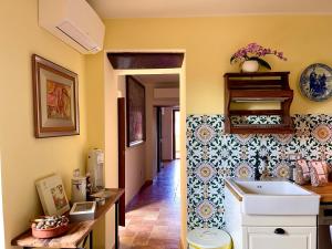 a kitchen with a sink and a wall with tiles at Donna Vittori - Borgo Agricolo in Paliano +61 photos