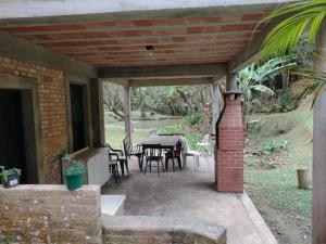 a patio with a table and chairs on it at Chalé em São Roque in São Roque