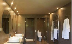 a bathroom with two sinks and a shower and two toilets at MEDOUSA VILLA in Porto Rafti +12 photos