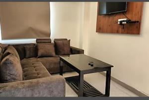 a living room with a couch and a coffee table at HOTEL DAISY in Guwahati