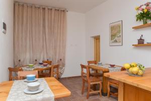 a dining room with wooden tables and chairs at Al Riparo Affittacamere in Finale Ligure