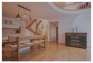 uma sala de estar com uma mesa de jantar e uma escadaria em Chalet Bergbauernhof em Afritz am See