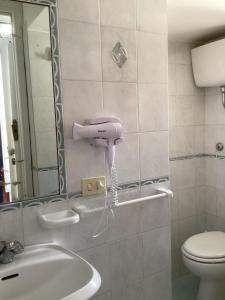 a bathroom with a sink and a toilet and a mirror at Capricornio Club Diffuso in Maiori