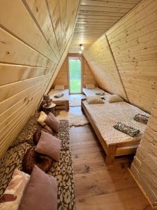 a room with three beds in a wooden house at Domek nad Potokiem w Beskidach in Rajcza