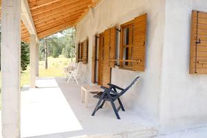 a chair sitting on the porch of a house at Vig in Njegovuđa