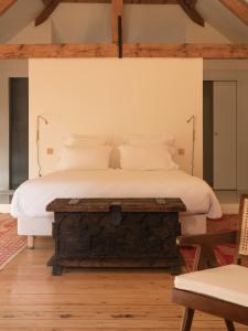a bedroom with a bed with white sheets and pillows at Petit Chateau Vercourt in Vercourt