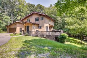 a large house with a porch and a yard at Lakefront New York Abode with Deck, Grill and Fire Pit in Mahopac