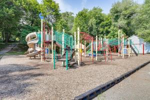 a playground with a slide in a park at Lakefront New York Abode with Deck, Grill and Fire Pit in Mahopac