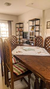 a wooden dining room table with chairs and a television at BELGRANO 124 - CORRIENTES in Corrientes