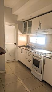 a kitchen with a stove and a refrigerator at BELGRANO 124 - CORRIENTES in Corrientes