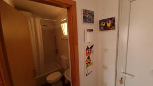 a bathroom with a toilet and a shower and a door at Art room JASMINA with sea view - Bikers and pets are welcome in Starigrad-Paklenica +19 photos