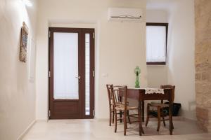 a dining room with a wooden table and chairs at N'incanto in Rutigliano