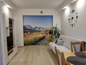 a living room with a wall mural of a mountain view at Apartament 51 in Gdynia