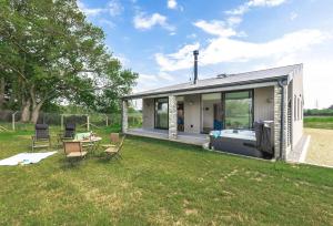 a tiny house with a bedroom and a garden at Lakeside Lodge by Grandeur Property in Sturminster Marshall