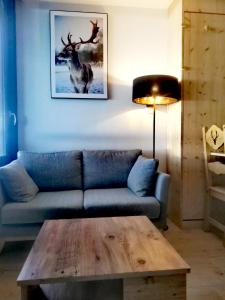 a living room with a couch and a wooden coffee table at Studio Pour 4 Personnes in Chamrousse