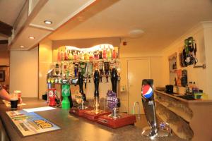 a bar with a counter with a lot of drinks at One Bedroom Apartment with Balcony at Colliford Tavern & Holiday Site in Bodmin
