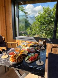 a table with a bunch of food on it at Maysa Suit Bungalov in Çamlıhemşin