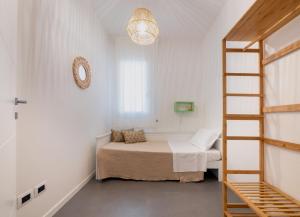 a small bedroom with a bed and a ladder at Casa al Mare 10 in Fano