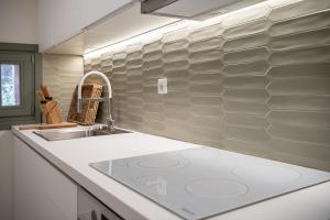 a kitchen with a sink and a counter top at Theros Home in Chania Town