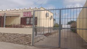 a gate in front of a building at La Baquiana 2 in Mercedes