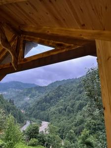 a view from the inside of a wooden cabin looking at a mountain at Maysa Suit Bungalov in Çamlıhemşin