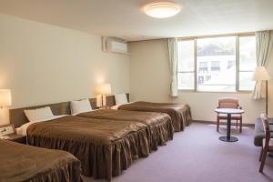 Postel nebo postele na pokoji v ubytování Hotel Oak Forest