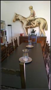 a dining room table with a horse statue on the wall at La Scheggia Holiday in Anghiari +38 photos
