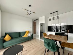 a living room with a green couch and a table at SDH 4 Radzymin comfortable apartment near Warsaw in Radzymin
