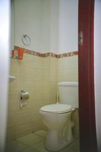 a bathroom with a white toilet in a room at Eagles nest III Furnished apartments in Nairobi