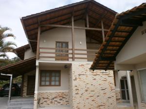 a house with a wooden roof at Krohberger Residence Hostel in Pomerode