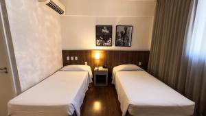 Cama ou camas em um quarto em Hotel Vivenzo Savassi Belo Horizonte