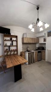 a kitchen with a wooden table in a room at Locazione turistica il boschetto in Martina Franca