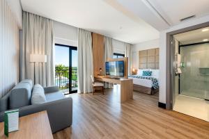 una camera d'albergo con letto e divano di Japy Golf Resort Hotel a Cabreúva