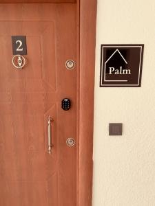 een houten deur met een postbord erop bij AQUA Suite Kemer in Kemer