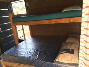 an empty bunk bed in a tiny house at Inti Huasi in La Paisanita