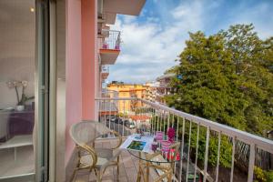 a balcony with a table and chairs on a balcony at Estate4home - L'onda viola in Sorrento