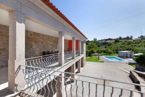 a balcony of a house with a swimming pool at Casa da Tomada - Minho's Guest in Braga