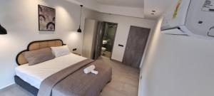 Ένα ή περισσότερα κρεβάτια σε δωμάτιο στο AMAL SUITES +12 φωτογραφίες