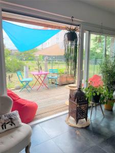 sala de estar con patio con mesa y sillas en A la villa du voyageur - proche Europa Park, Strasbourg et Colmar en Sélestat