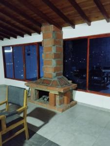 a brick fireplace in a living room with a view at Hermosa vista GH #4 in Guarne