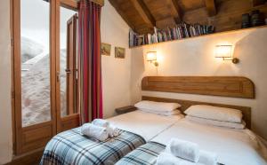 a bedroom with two beds and a window at Chalet Barragiste in Courchevel