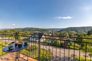 a balcony with a table and a view of a road at Villa Kasztelan Apartamenty in Ustrzyki Dolne