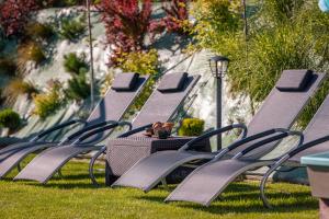 a row of empty benches sitting in the grass at Villa Kasztelan Apartamenty in Ustrzyki Dolne +138 photos